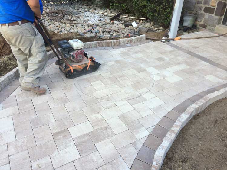Tamping marked location of paver medallion